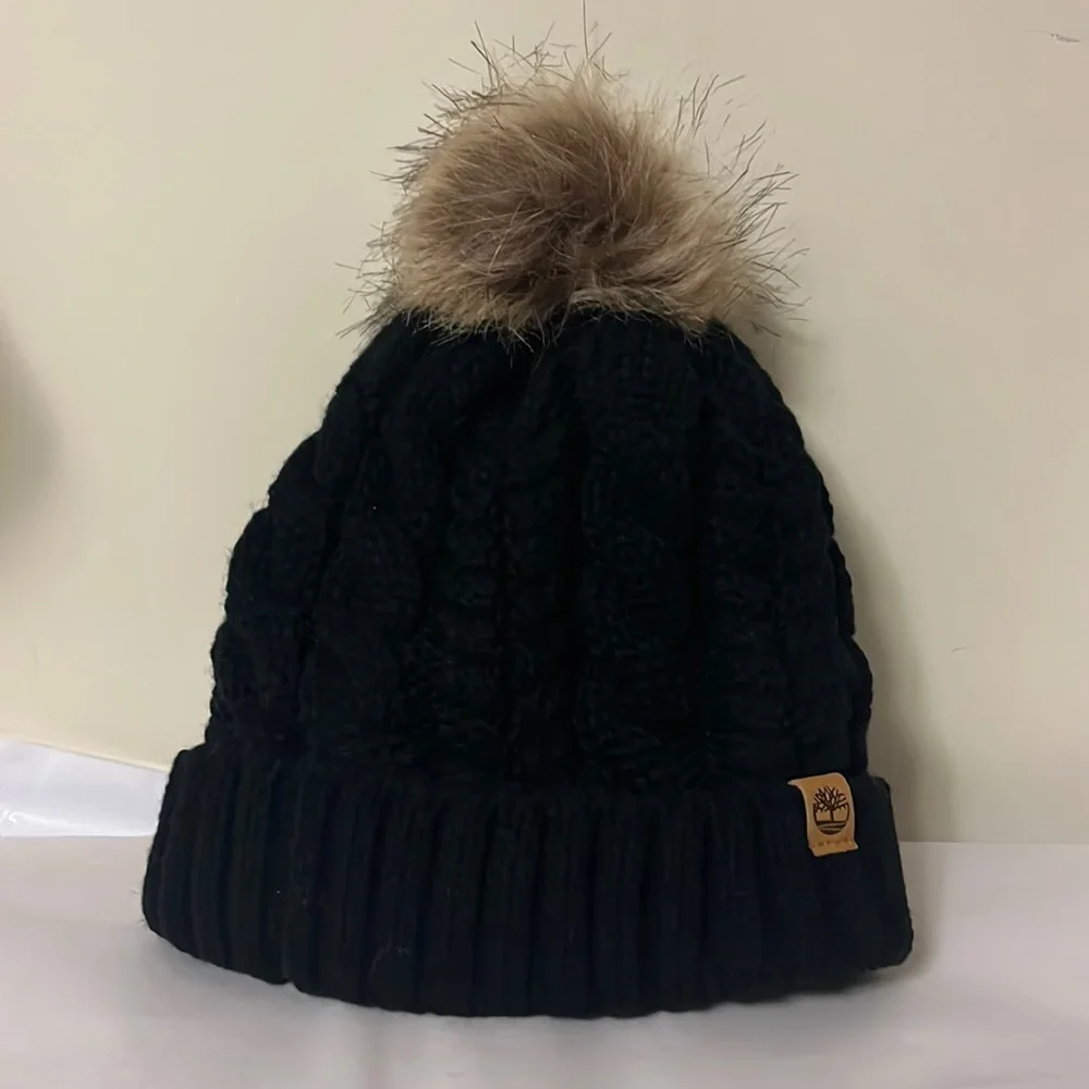 Timberland black cable knit, fleece lined hat with furry Pom on top, new